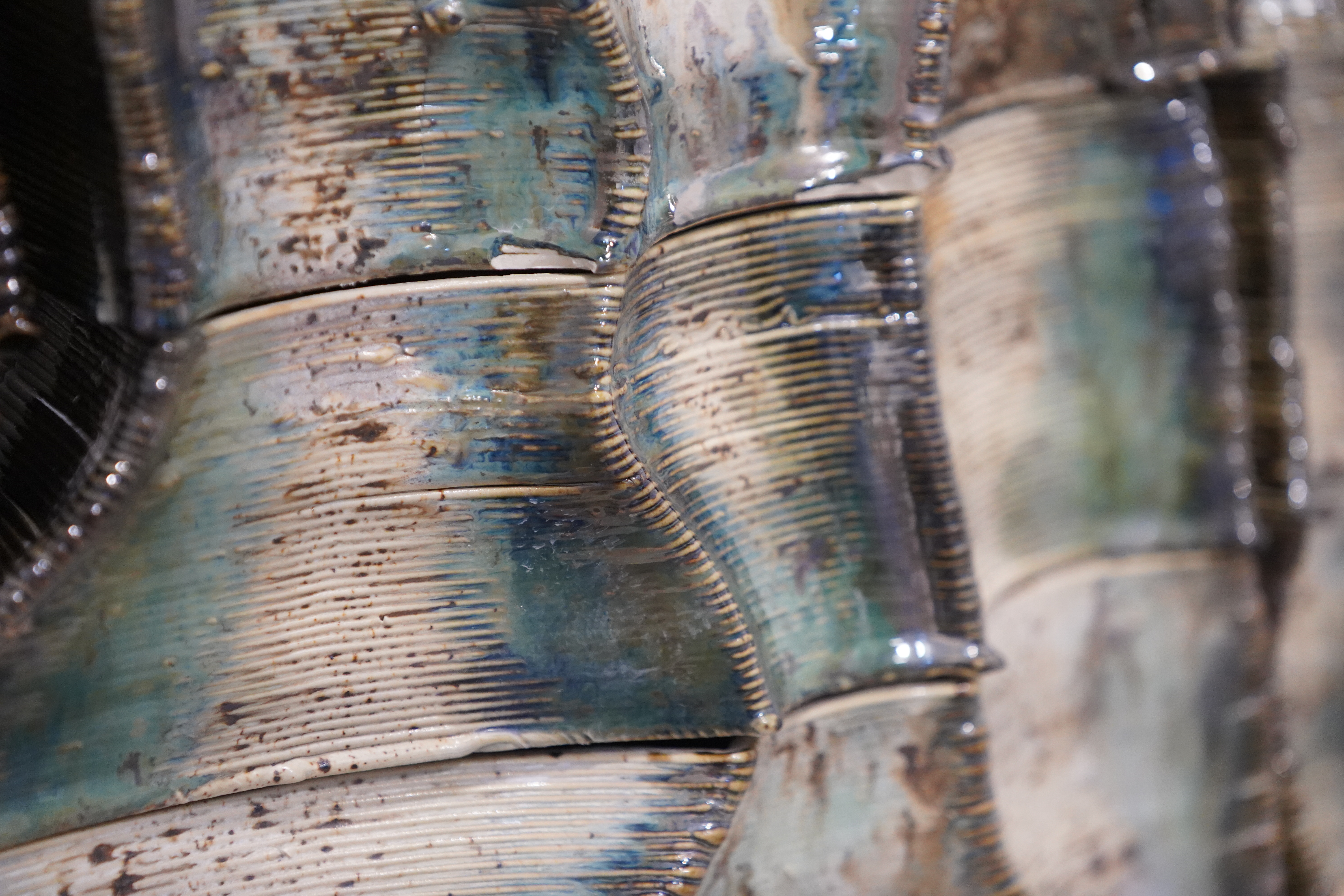 Glaze detail — reactive whites and chrome pooling between printed layers