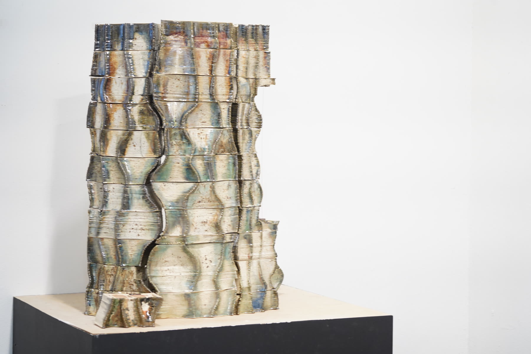 Fired, glazed ceramic wall — earth-toned palette of the post-fire landscape