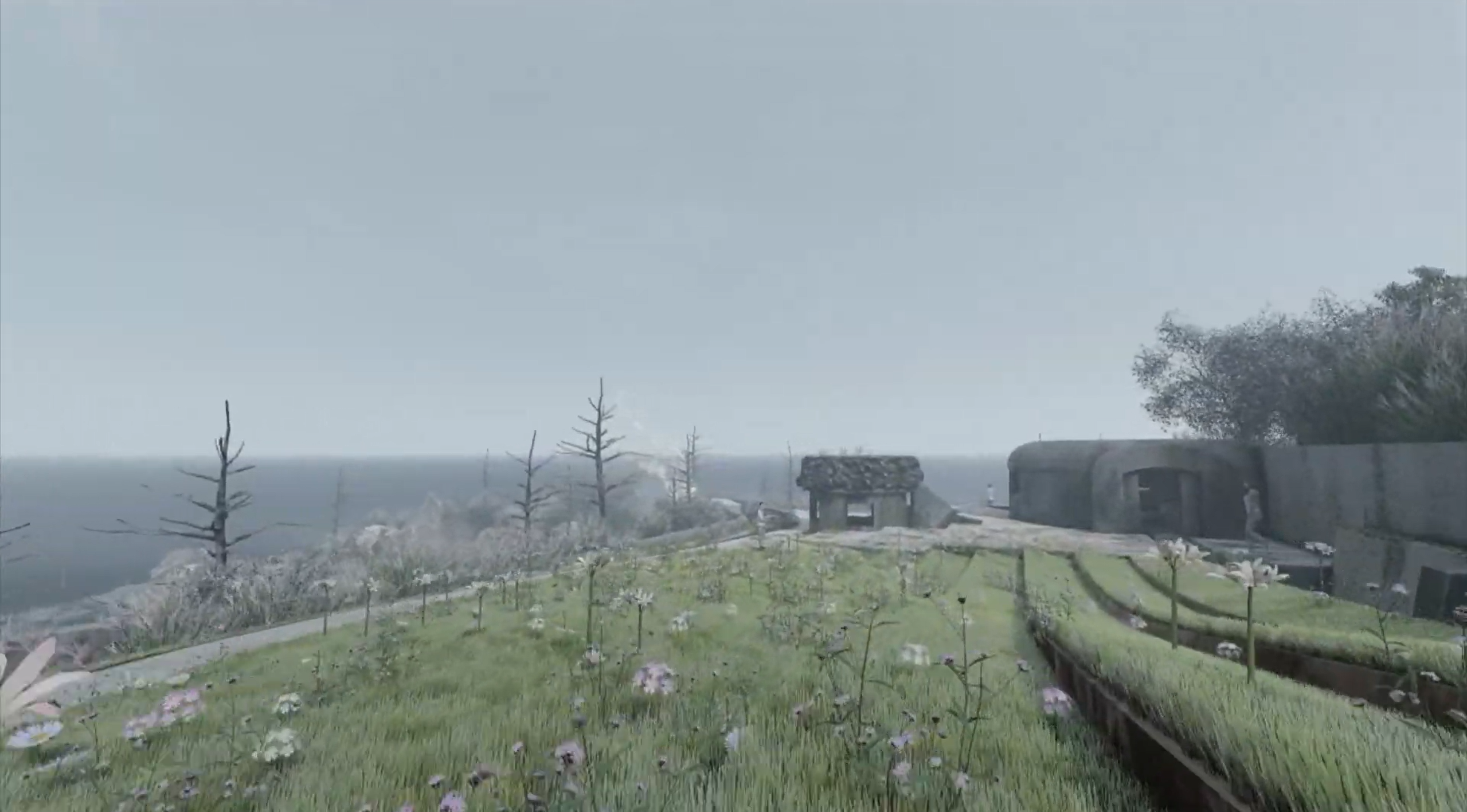A gateway and round bunker on a misty wildflower plateau